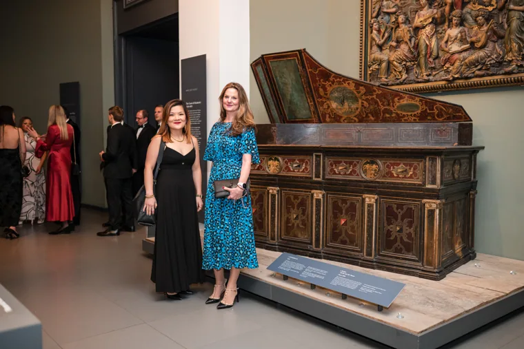 Three women walking past the historic exhibits at the Chambers UK Awards winter edition.