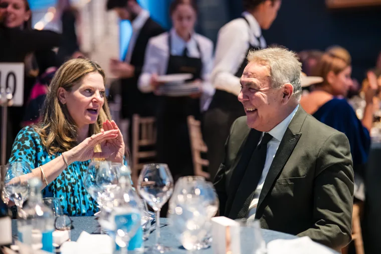 Two guests in animated conversation at dinner at the Chambers UK Awards winter edition.