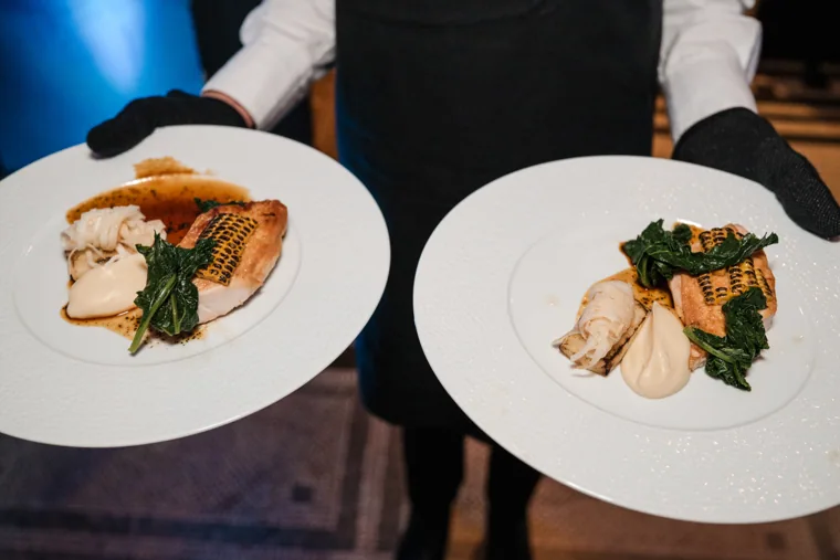 Two plated main courses being served at the Chambers UK Awards winter edition.