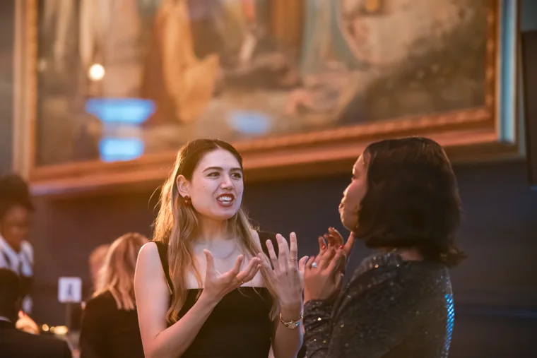 Two women chatting during dinner at the Chambers UK Awards winter edition.