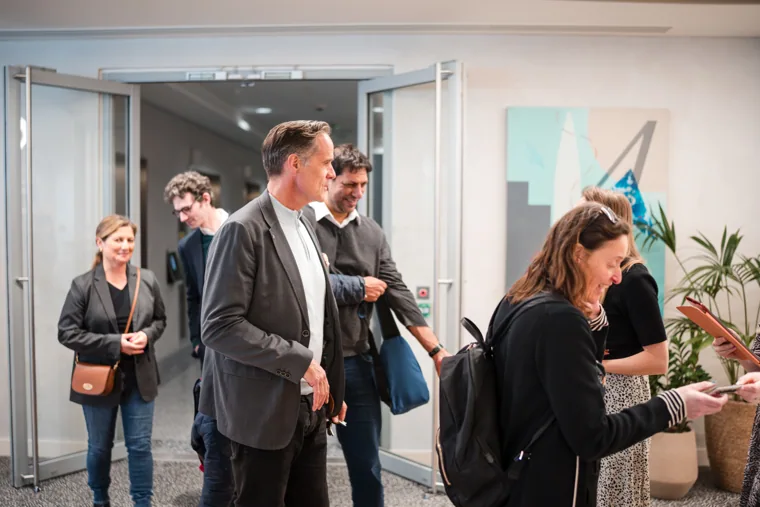 Attendees arriving for the Goodwin discussion at the Goodwin networking event.