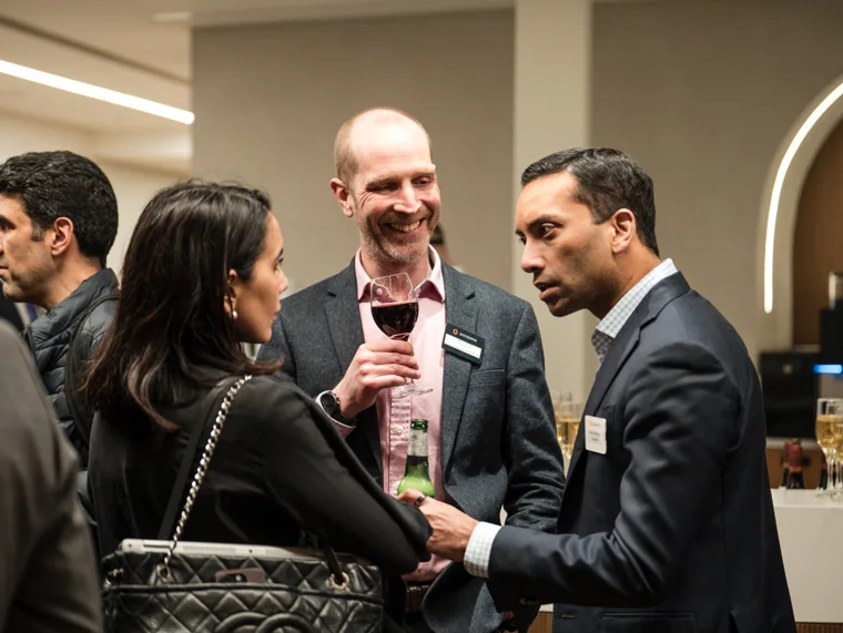 Guests enjoying a lively conversation at the reception at the Goodwin networking event.