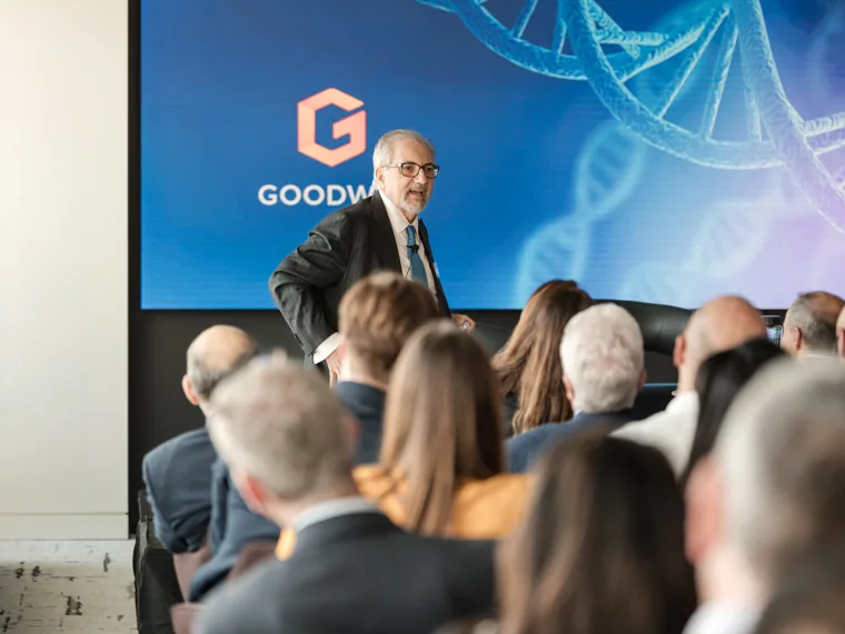 A speaker addressing the seated audience at the Goodwin networking event.