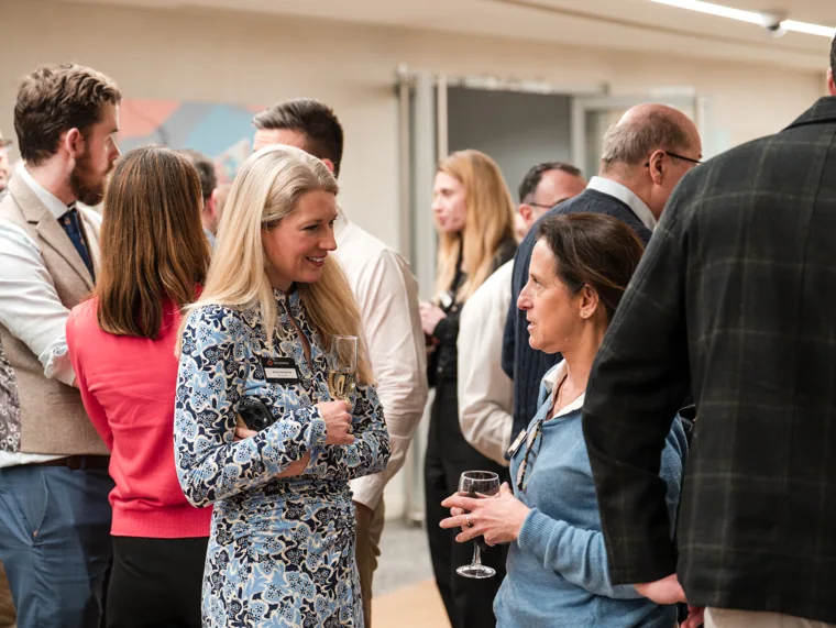 A small group talking in the networking space at the Goodwin networking event.