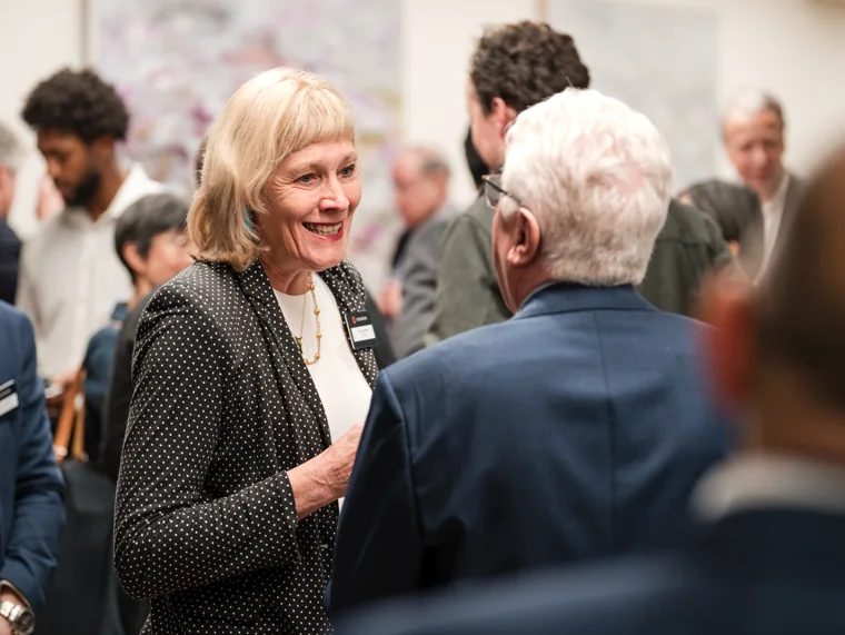 An attendee smiling during a networking conversation at the Goodwin networking event.