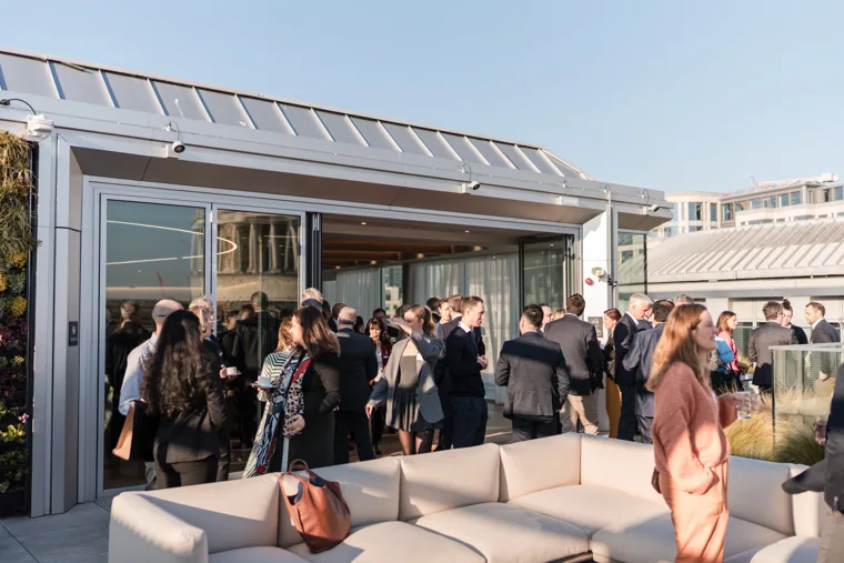 A wide view of the terrace reception at the Goodwin networking event.