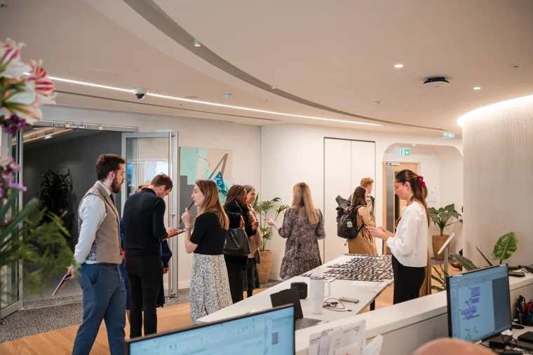 Guests gathering in the bright reception room at the Goodwin networking event.