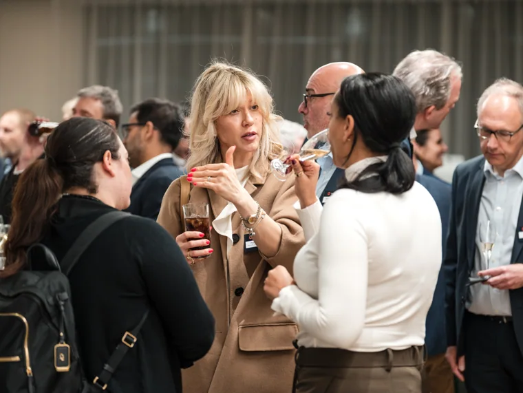 Guests enjoying a conversation during the reception at the Goodwin networking event.