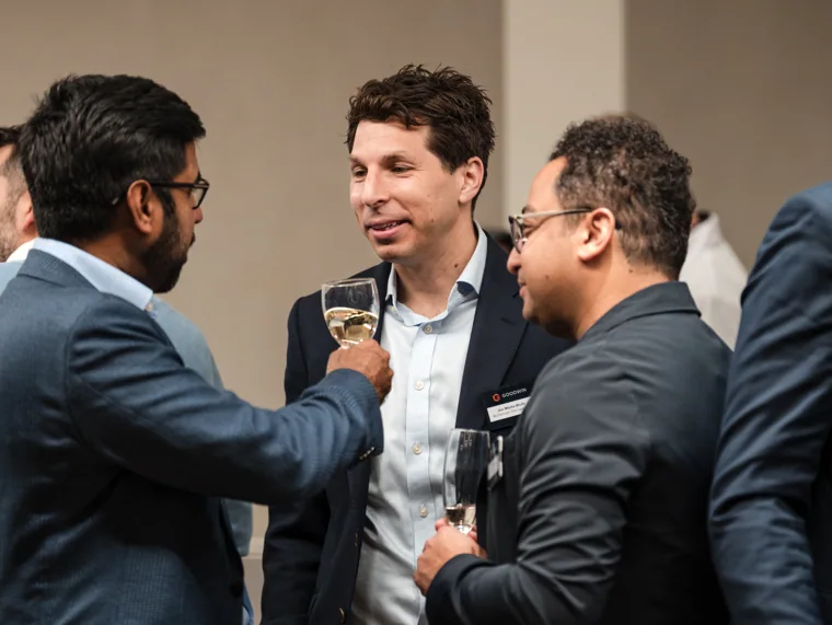 Guests sharing an animated conversation at the Goodwin networking event.