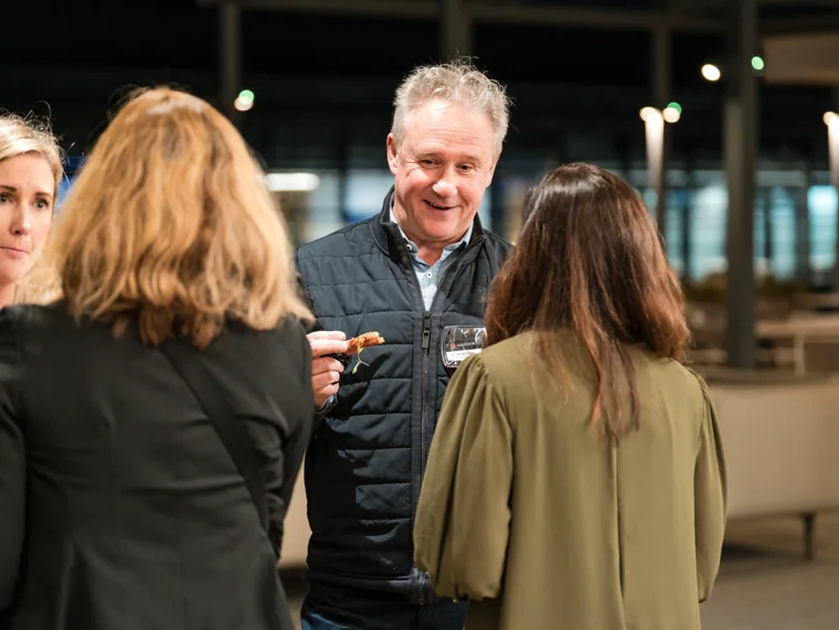 An animated conversation among guests at the Goodwin networking event.