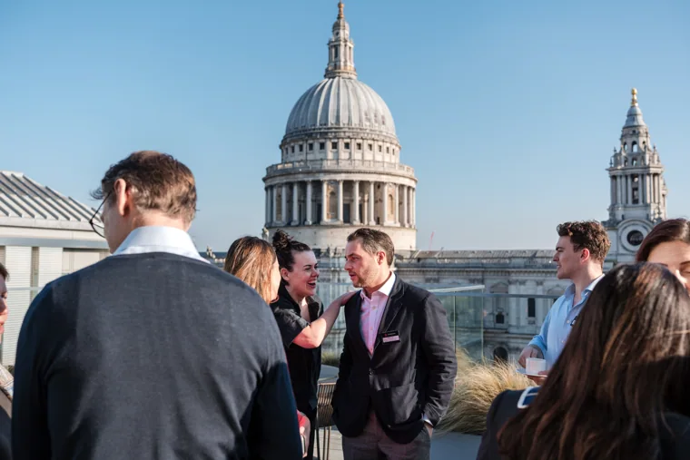Attendees gathering outside with St Paul’s in view at the Goodwin networking event.