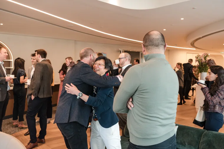 A group chatting in the reception space at the Goodwin networking event.