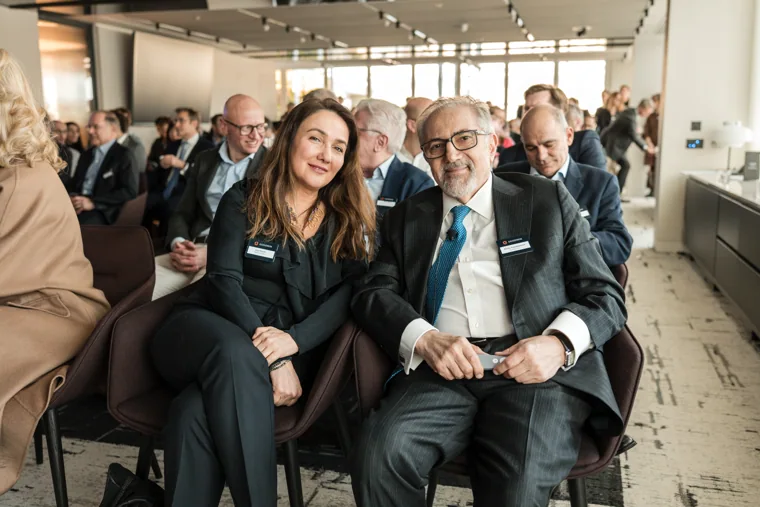 Two attendees pictured together in a seating area at the Goodwin networking event.