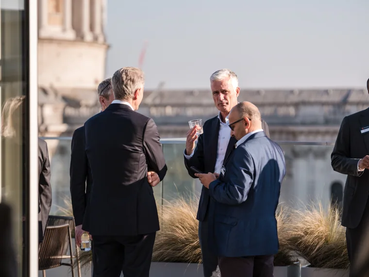 A terrace conversation with the city behind it at the Goodwin networking event.