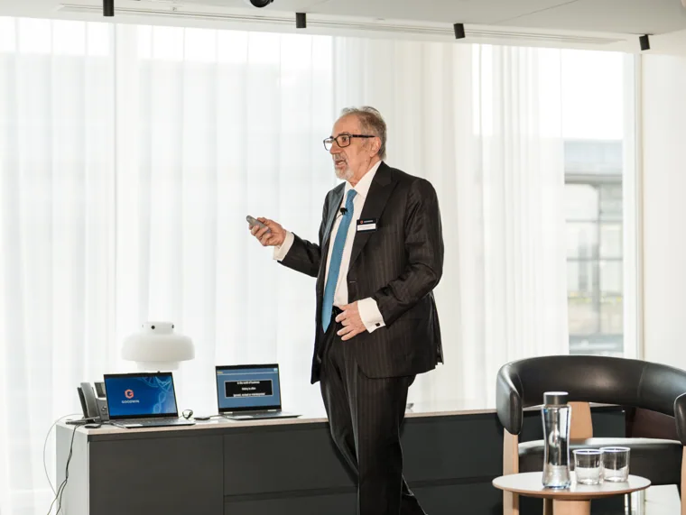 A speaker presenting from the front of the room at the Goodwin networking event.