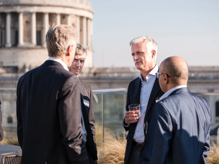 Guests conversing with St Paul’s Cathedral beyond at the Goodwin networking event.