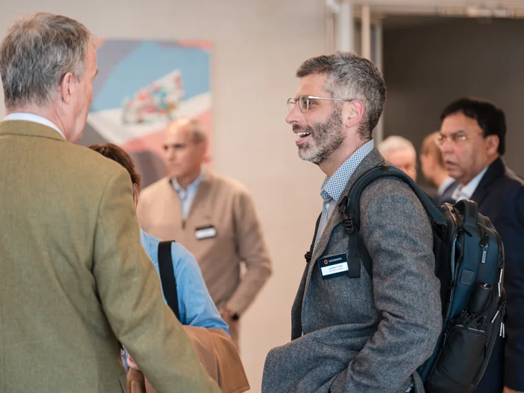 Guests sharing a drink and conversation at the Goodwin networking event.
