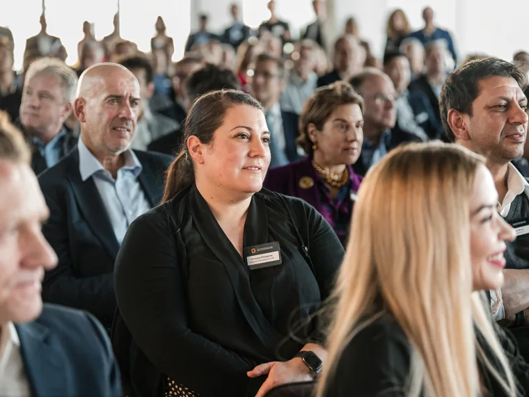 A close view of attentive audience members at the Goodwin networking event.