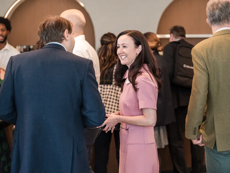 Two guests speaking in the reception area at the Goodwin networking event.