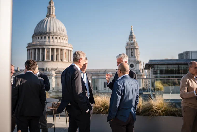 A group taking in the view from the event terrace at the Goodwin networking event.