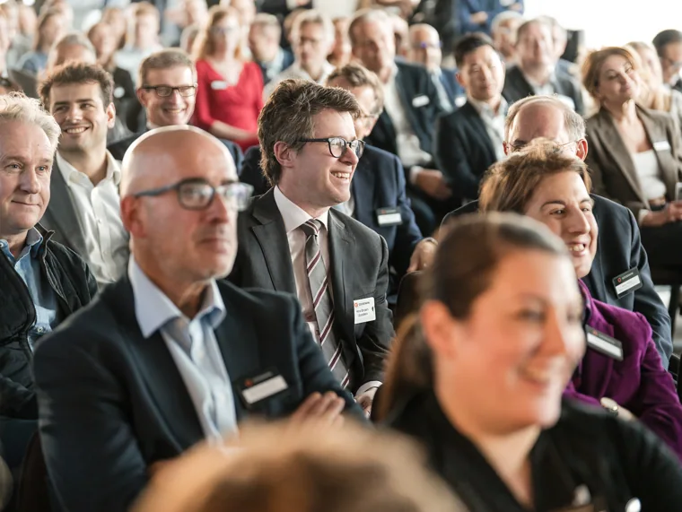 Attendees listening from the front rows at the Goodwin networking event.