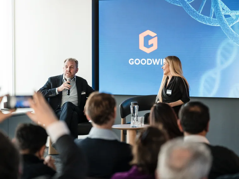 A speaker and interviewer on the Goodwin stage at the Goodwin networking event.