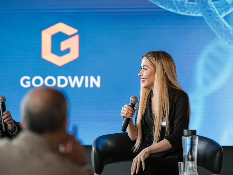 An interviewer speaking on the Goodwin stage at the Goodwin networking event.
