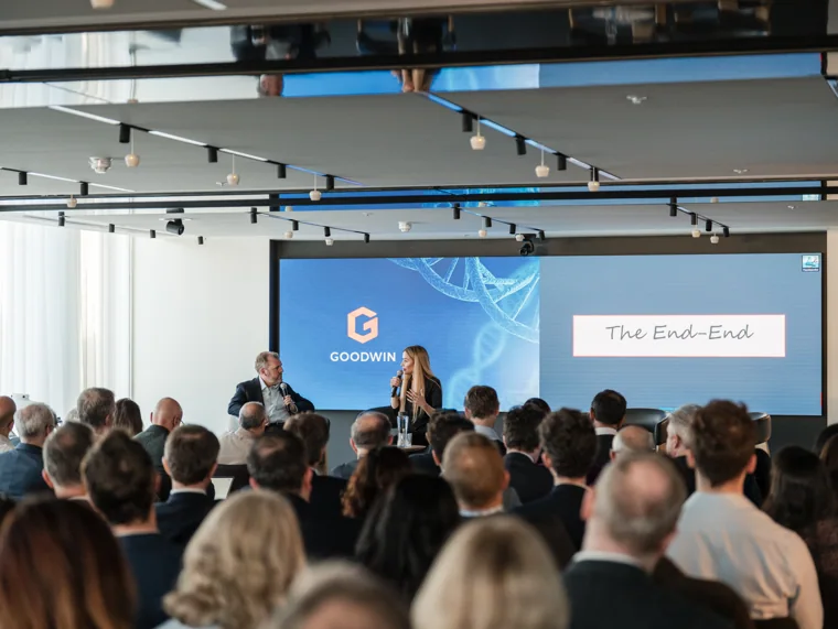 The audience and stage during a discussion at the Goodwin networking event.