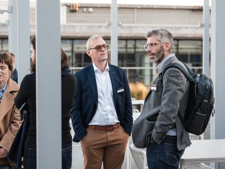 Two guests talking on the terrace at the Goodwin networking event.
