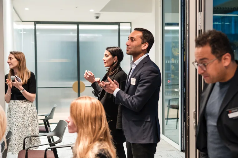 An attendee asking a question during the session at the Goodwin networking event.