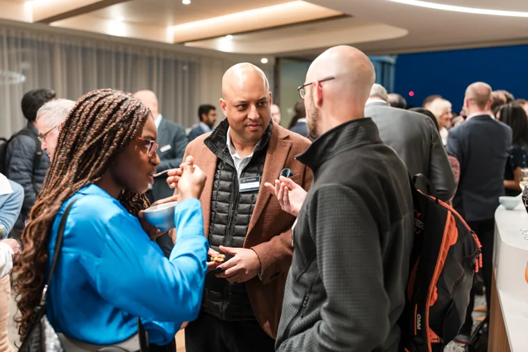 A group talking together in the reception space at the Goodwin networking event.