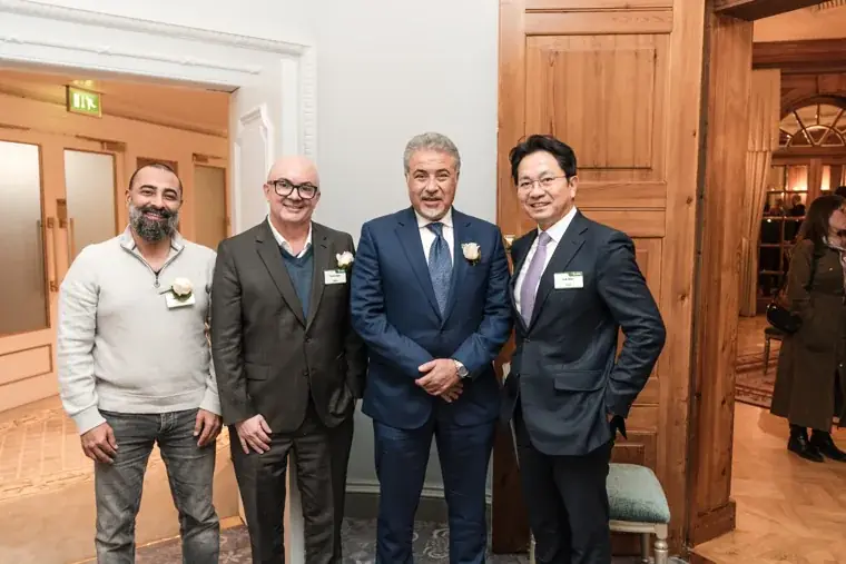A group of guests posing in the reception room at the S-OIL European customer dinner.