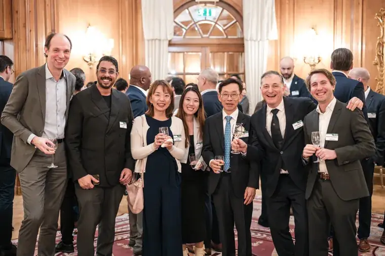 A group of guests posing together at the reception at the S-OIL European customer dinner.
