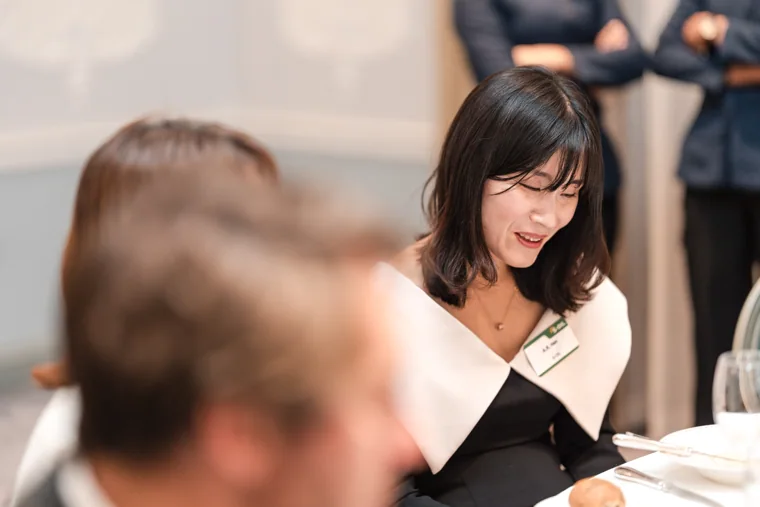 A guest looking down at the dinner table at the S-OIL European customer dinner.