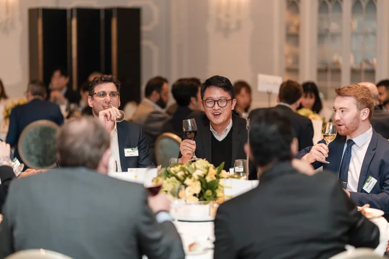 A table of guests joining a toast at the S-OIL European customer dinner.