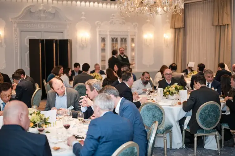 A wide view of dinner tables and guests at the S-OIL European customer dinner.