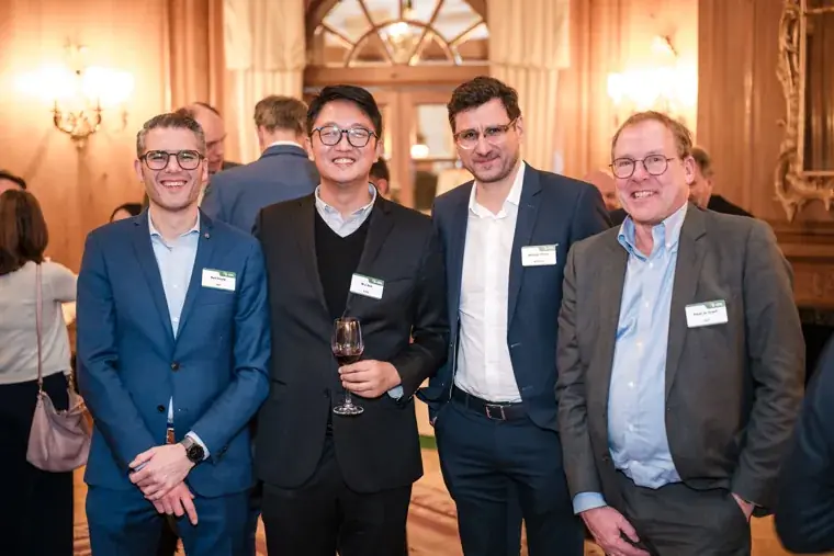 Four guests smiling for a group portrait at the S-OIL European customer dinner.