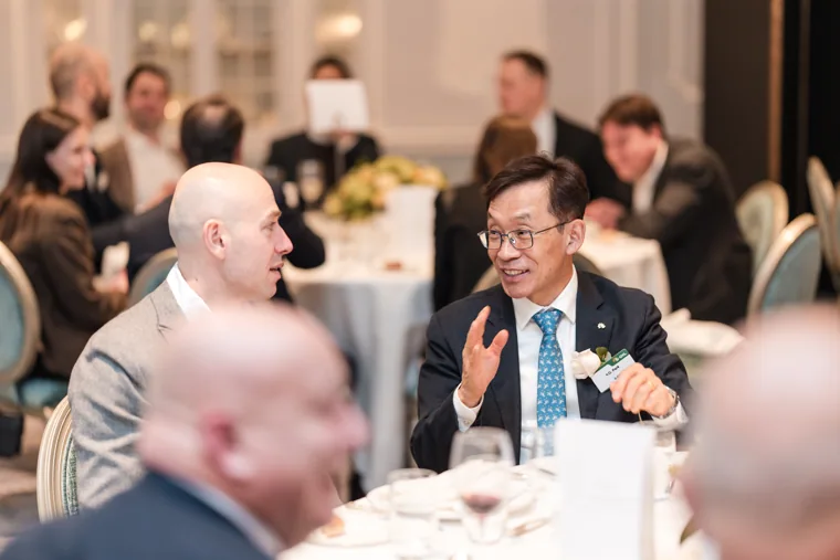 Guests chatting around the table at the S-OIL European customer dinner.