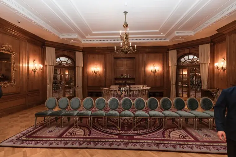 The wood-panelled room prepared for a group portrait at the S-OIL European customer dinner.