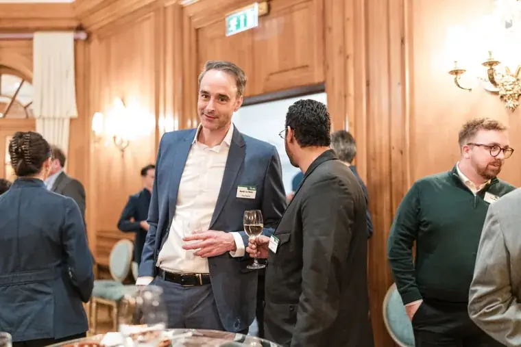 Three guests in conversation at the reception at the S-OIL European customer dinner.