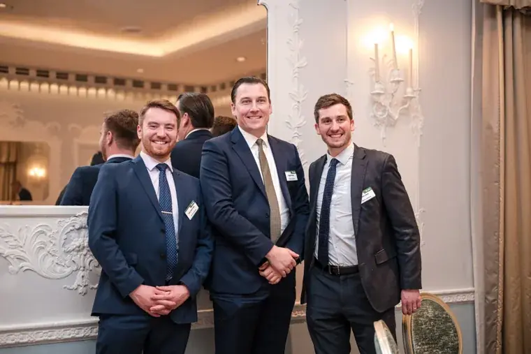 Three guests posing at the event at the S-OIL European customer dinner.