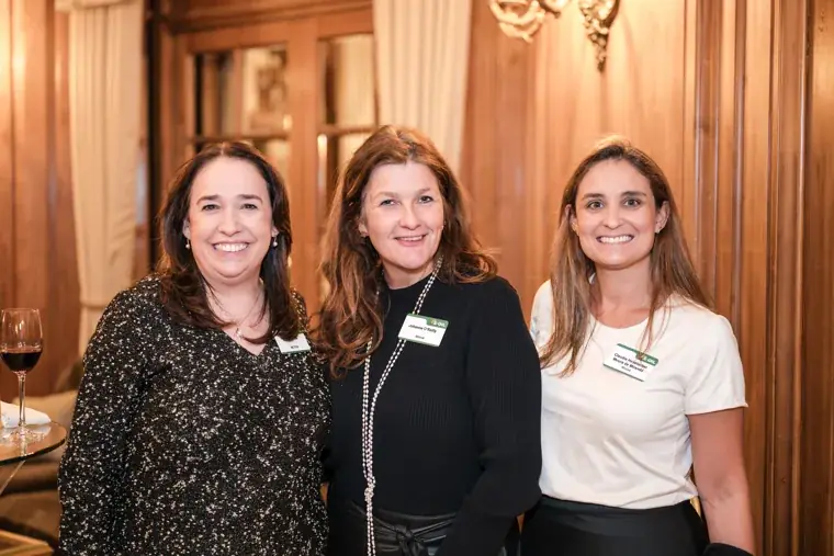 Three women posing together at the reception at the S-OIL European customer dinner.