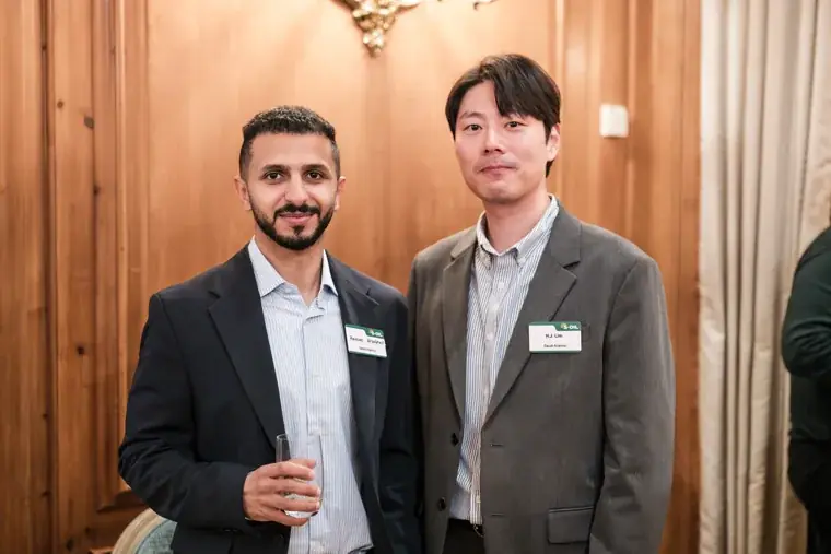 Two guests posing in the reception room at the S-OIL European customer dinner.