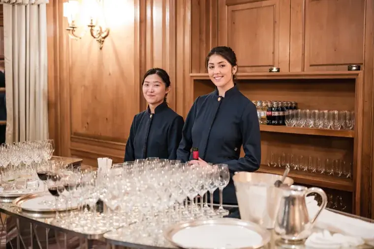 Two members of the service team beside glasses at the S-OIL European customer dinner.