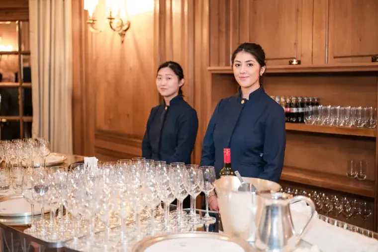 Two members of the service team beside the drinks station at the S-OIL European customer dinner.