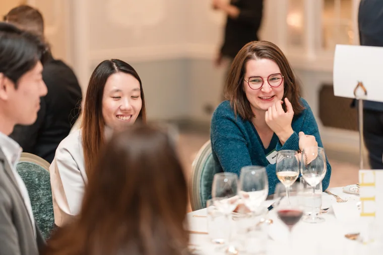 Two women smiling during the dinner at the S-OIL European customer dinner.